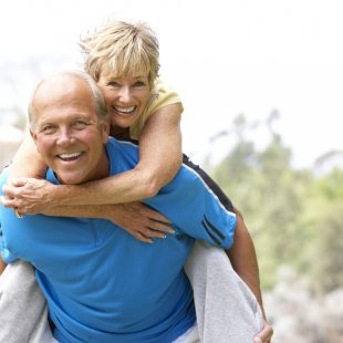Senior Couple Exercising In Park