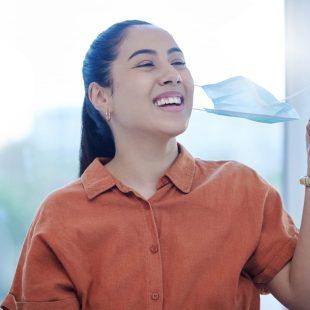 happy-woman-removes-face-mask